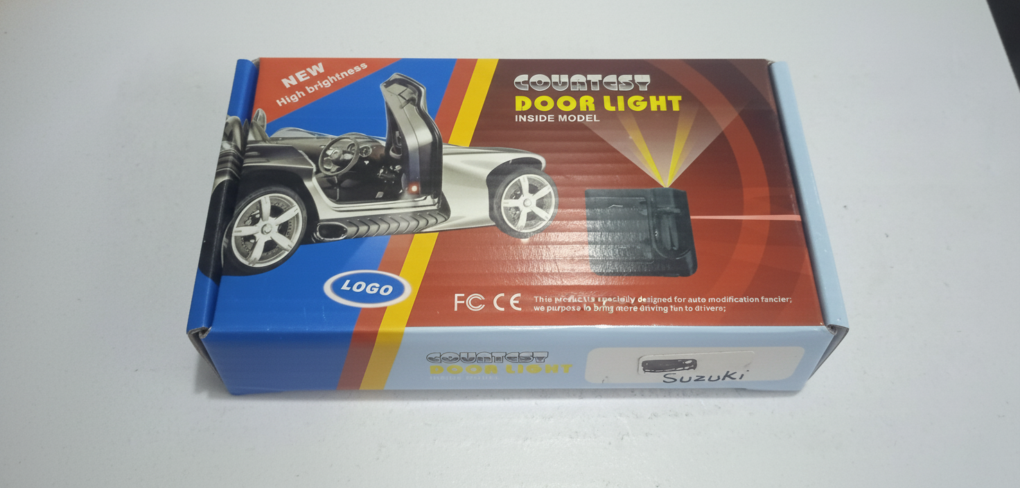 Box for a car door light with Ford logo and branding