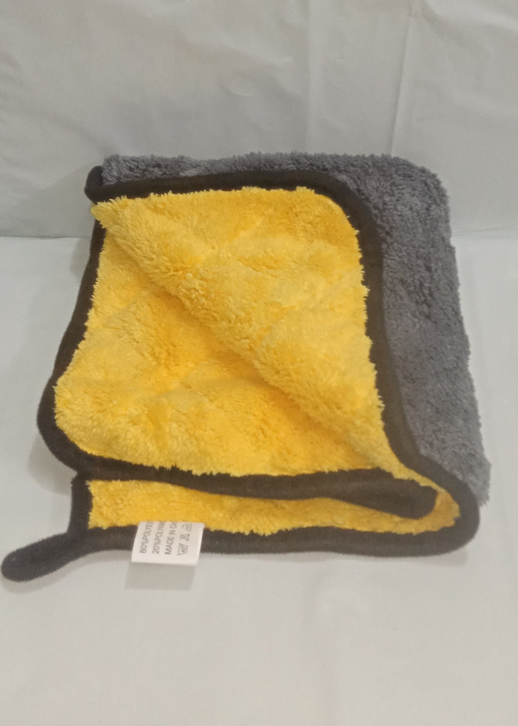 Gray and yellow towel on a white background