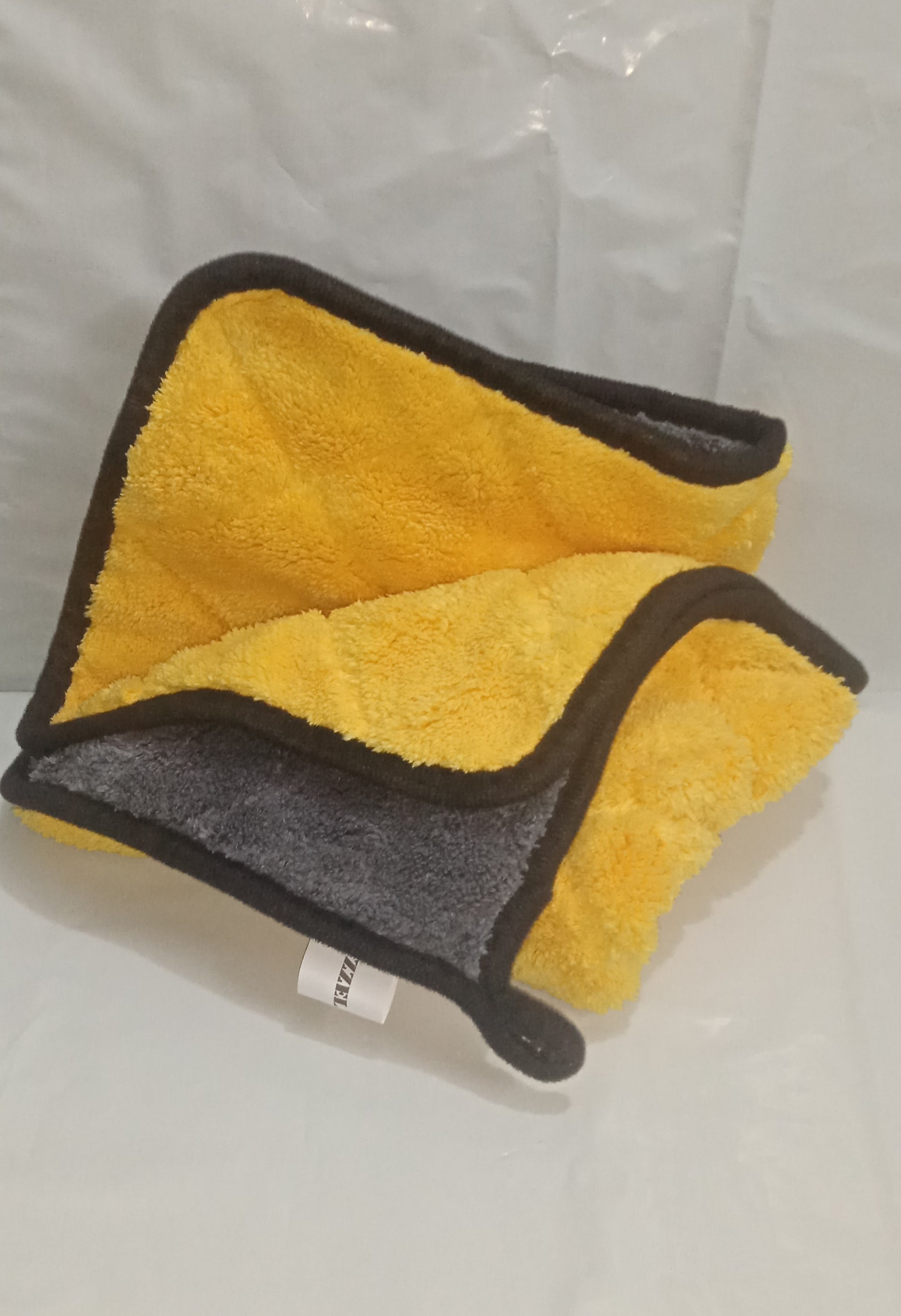 Yellow and gray towel on a white background