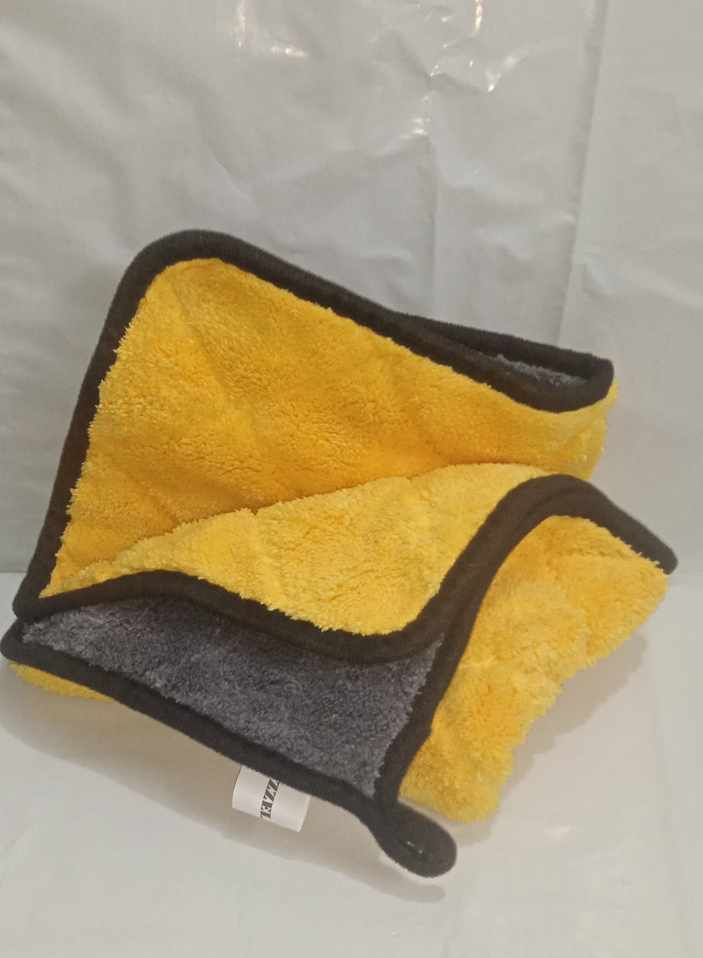 Yellow and gray towel on a white background