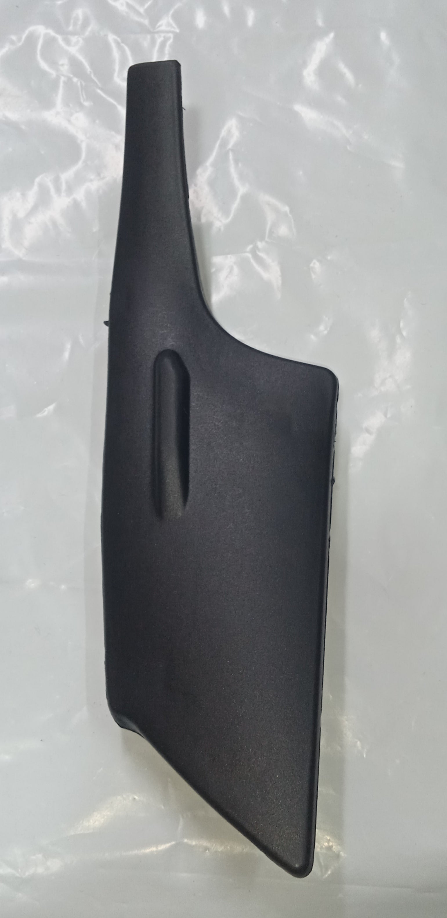 Black plastic car part on a light gray background