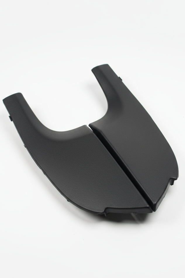 Black plastic car part on a light gray background