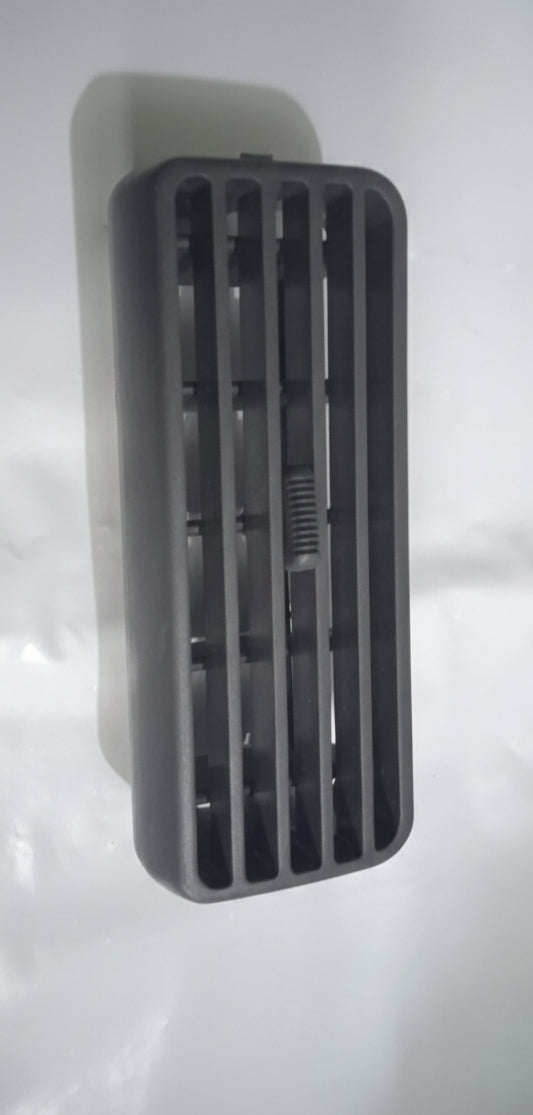 Black rectangular object with slits on a white background