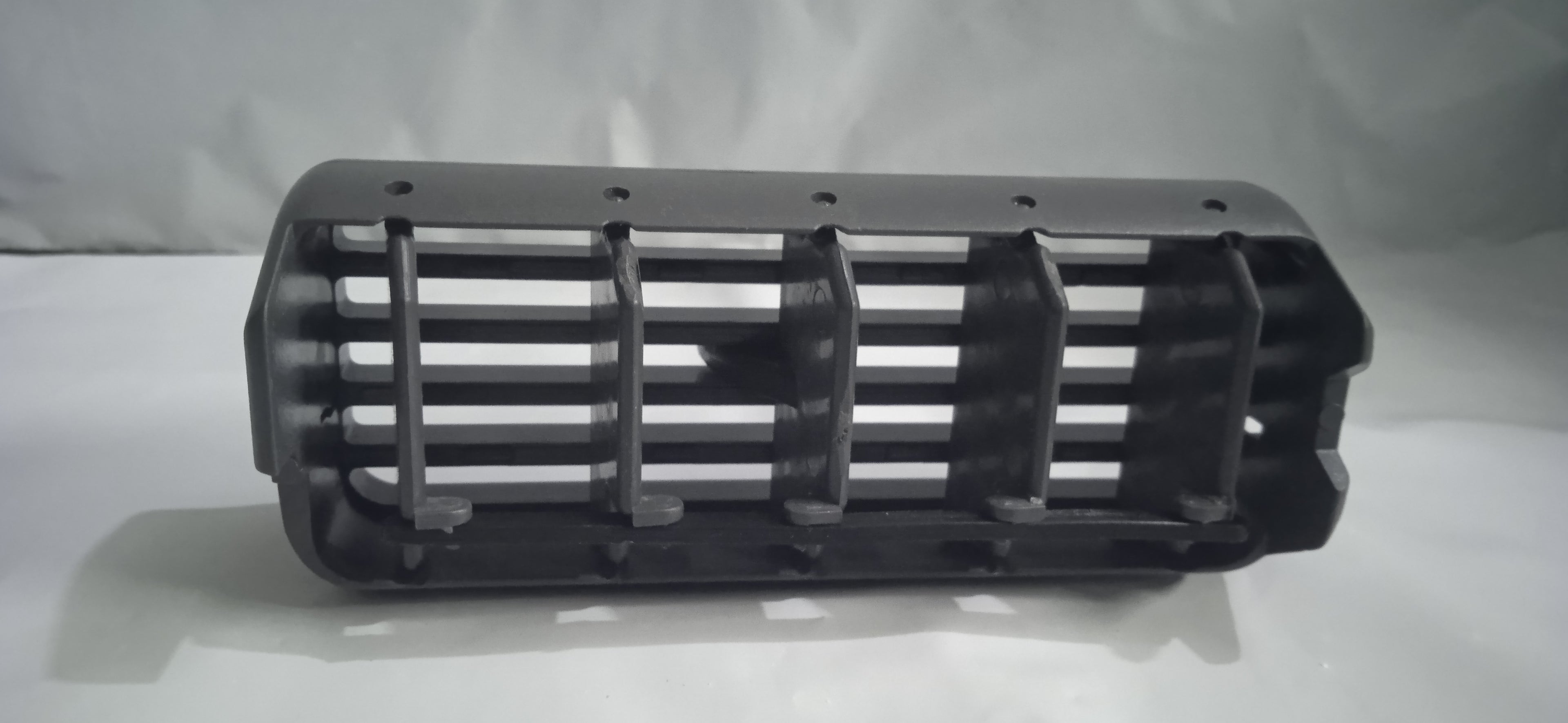 Black metal grille on a white background