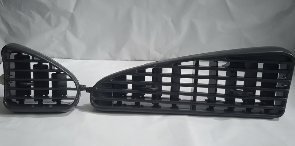 Two black car grilles on a white background