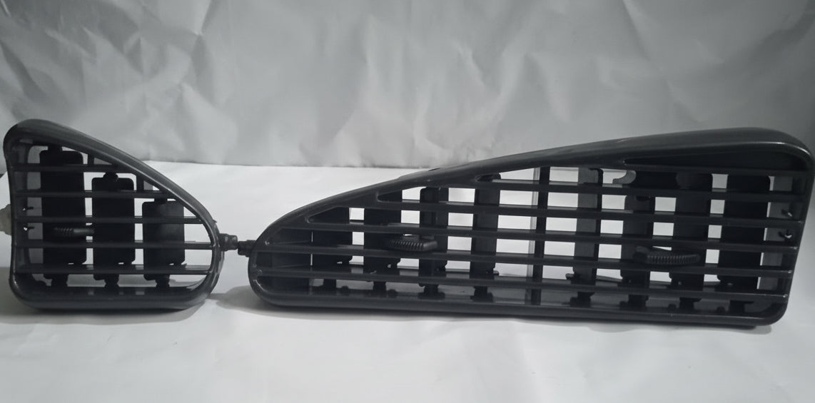 Two black car grilles on a white background