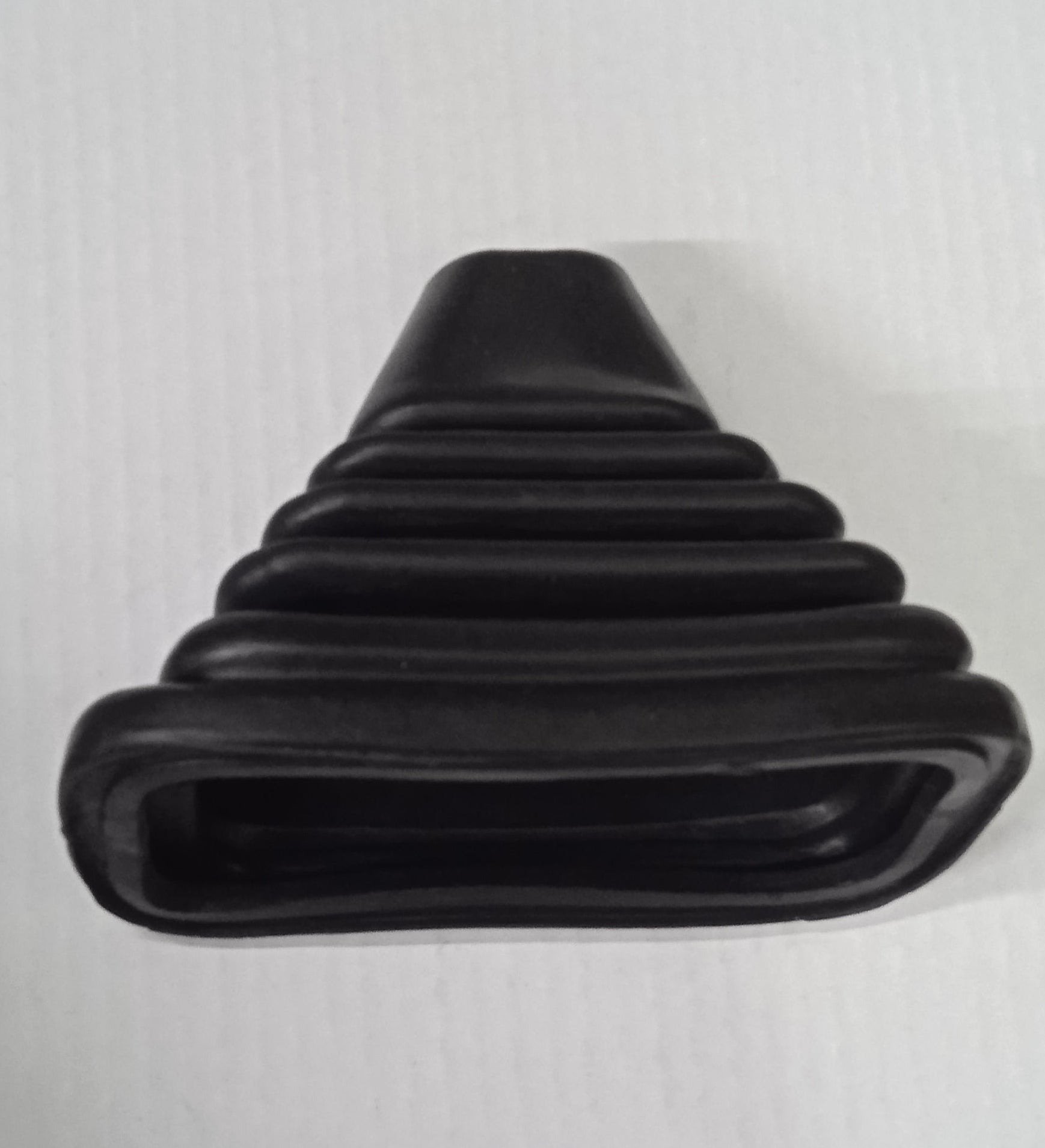 Black rubber grommet on a light gray background