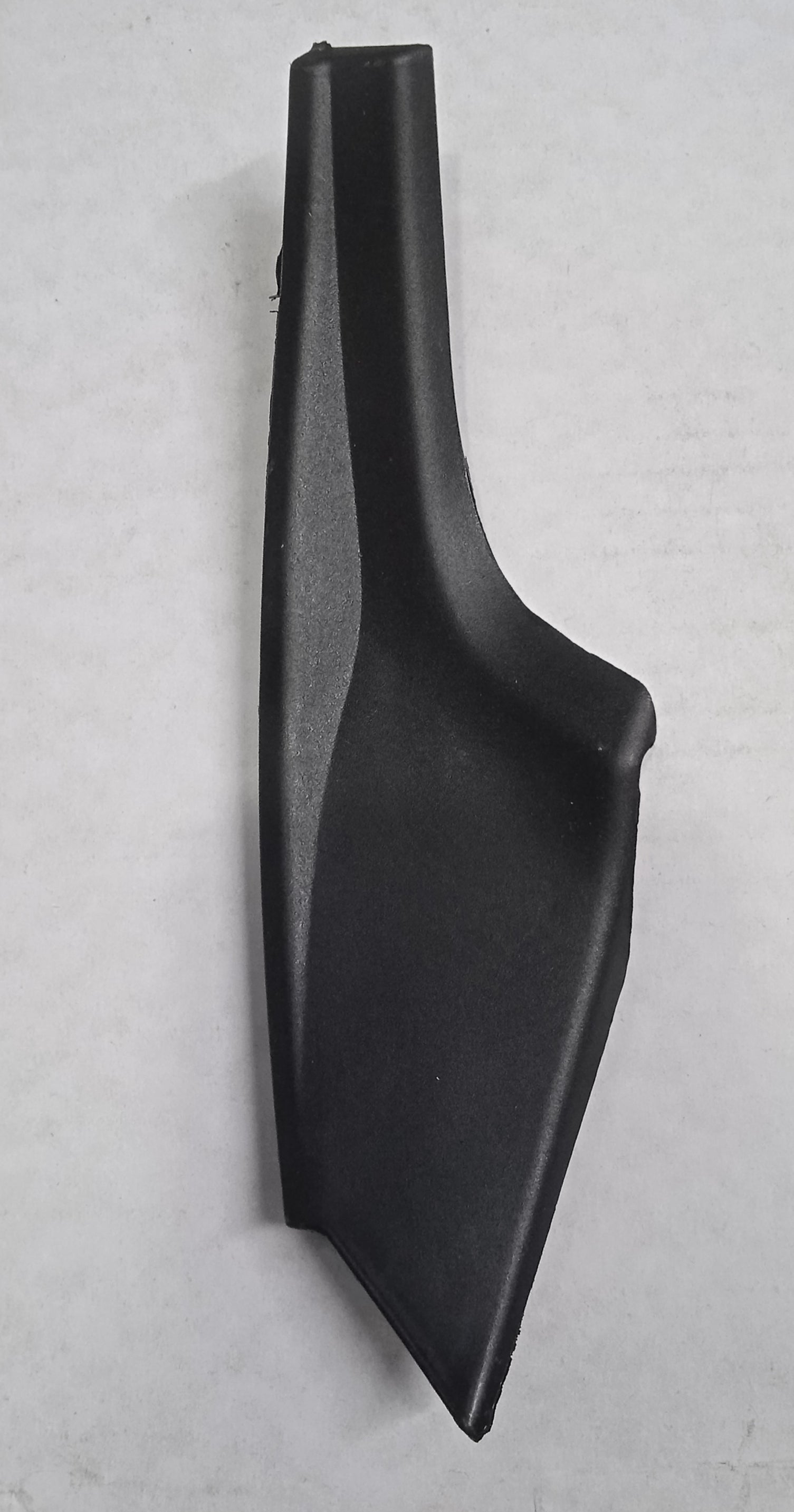 Black plastic car interior component on a gray background