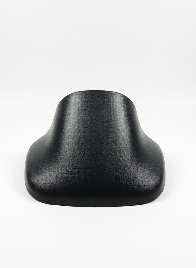 Black rubber boot on a textured white surface