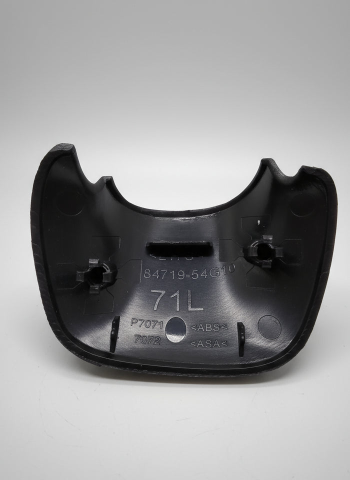 Black metal clip with engraved text on a textured surface