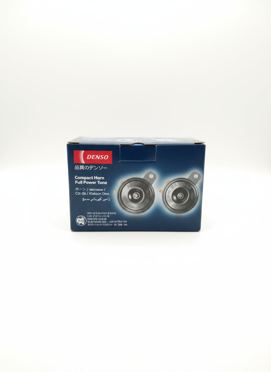 Denso compact horn packaging on a wooden surface