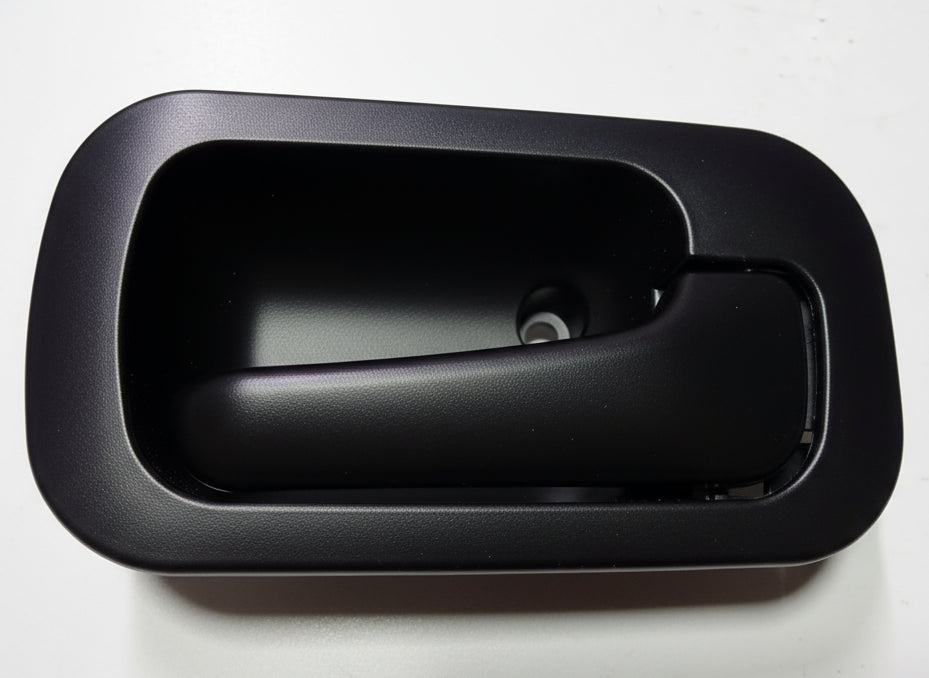 Gray interior car door handle on a light gray background