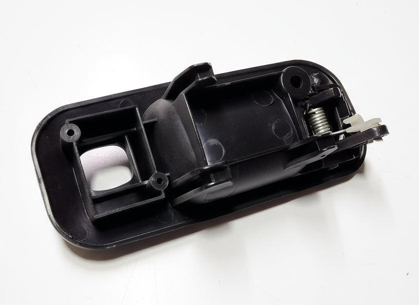 Black plastic component on a white background