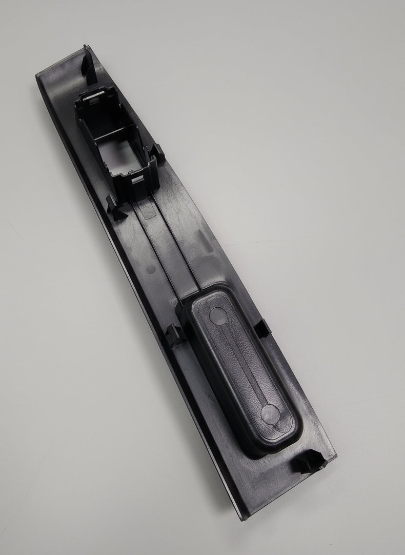 Black plastic component on a marble floor