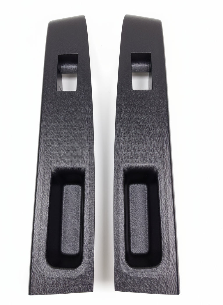 Two black car door handles on a marble floor