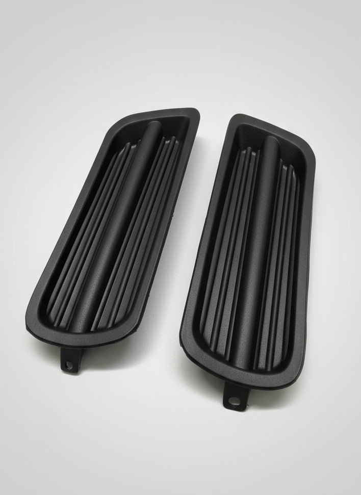 Two black plastic components on a gray background