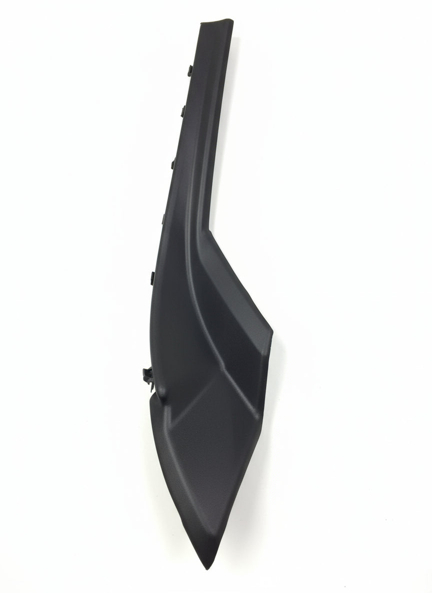 Black plastic car part on a tiled floor