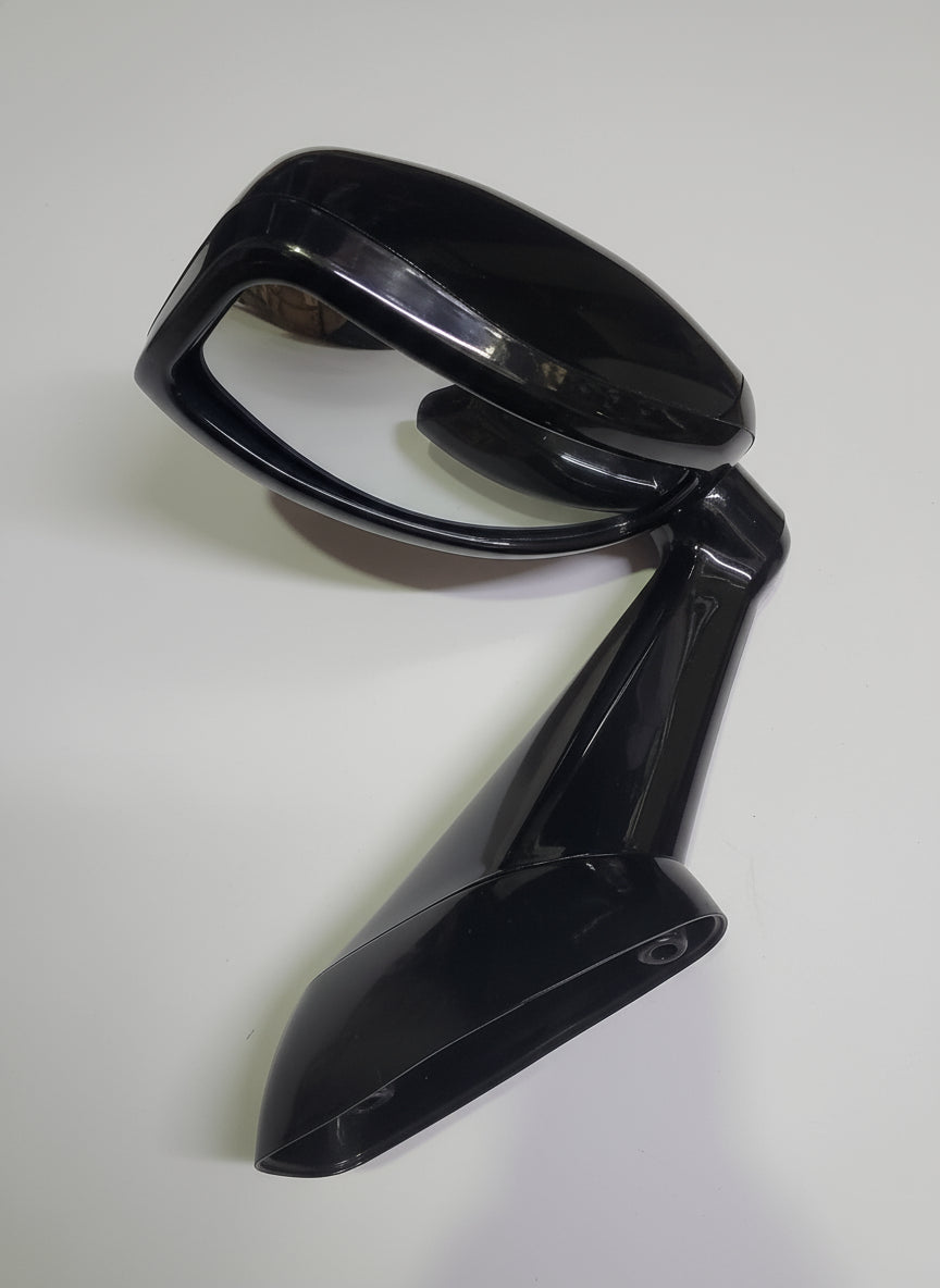 Black car mirror on a pink box with a white object inside, on a marble surface.