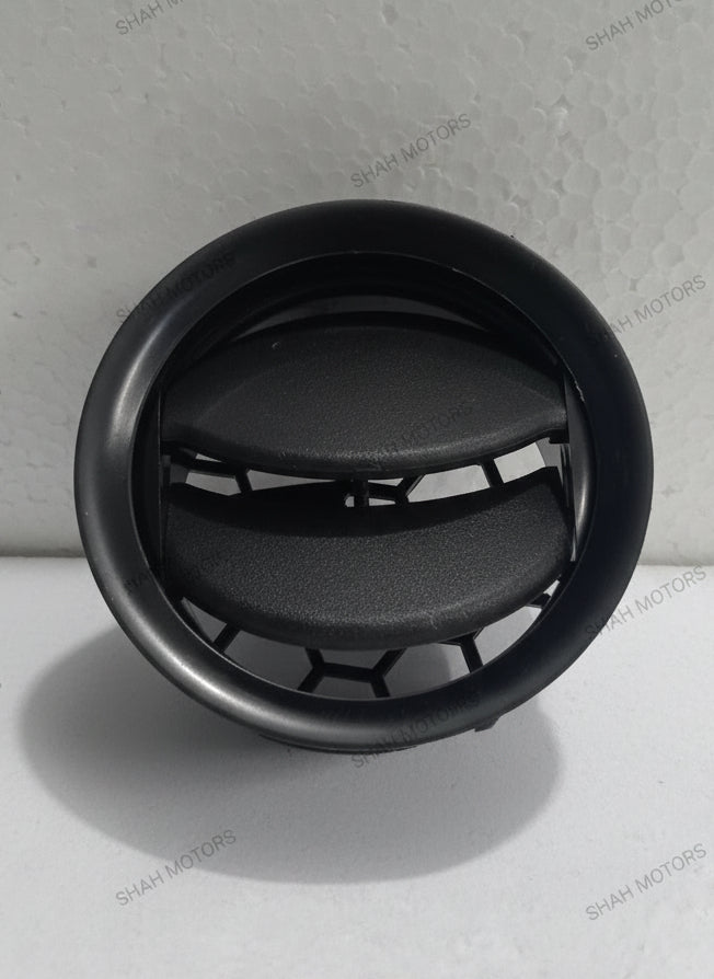 Black circular air vent on a gray background