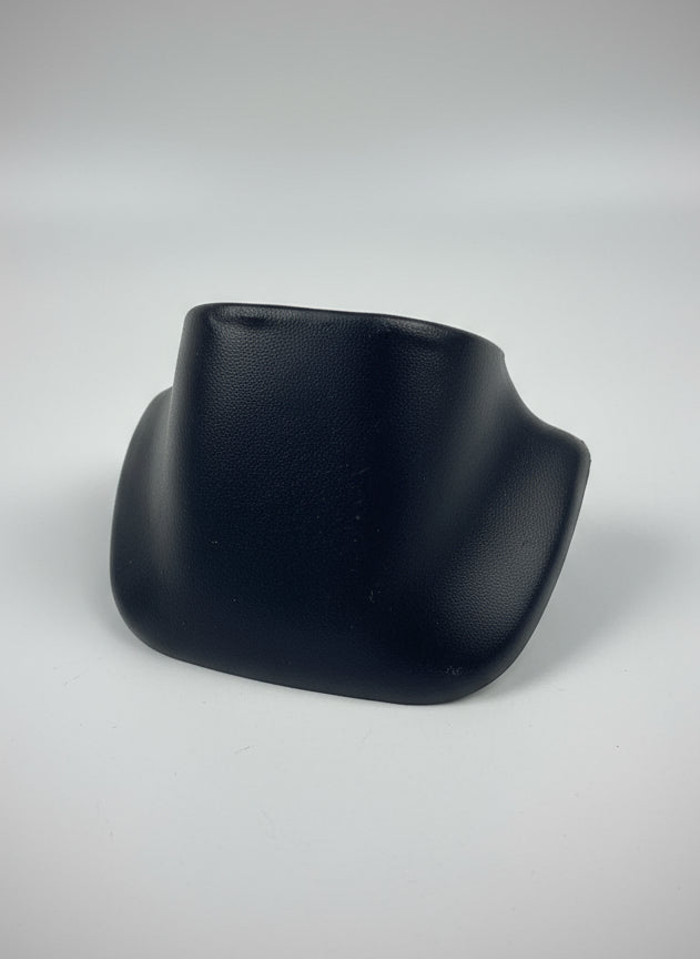 Black plastic object on a white tiled floor