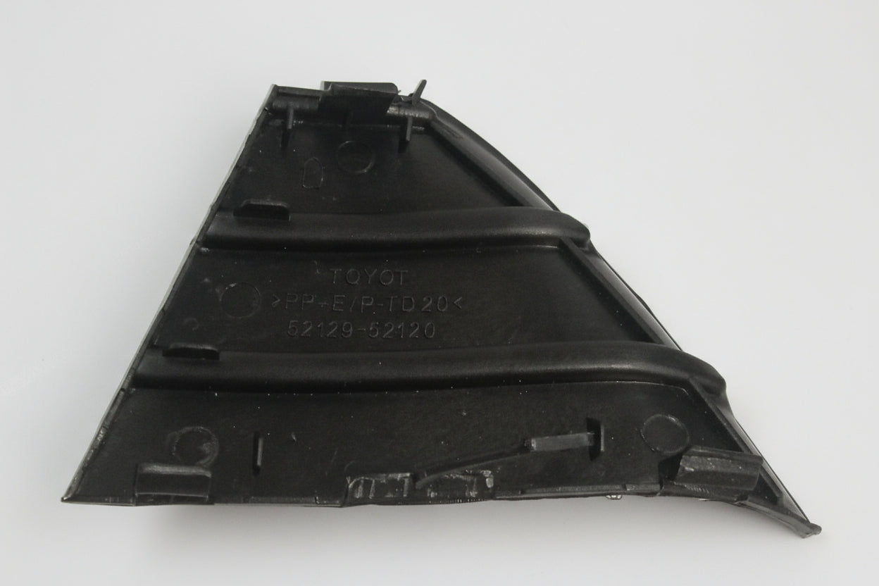 Black plastic automotive part on a light gray background