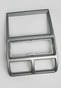 Metallic car dashboard panel with cutouts on a gray background