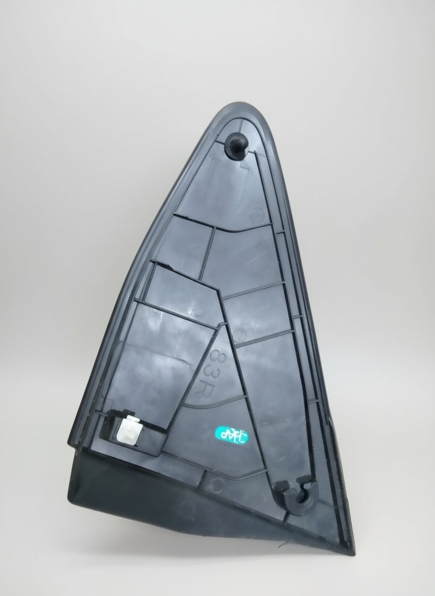 Person holding a black triangular object with a brand logo in a store setting