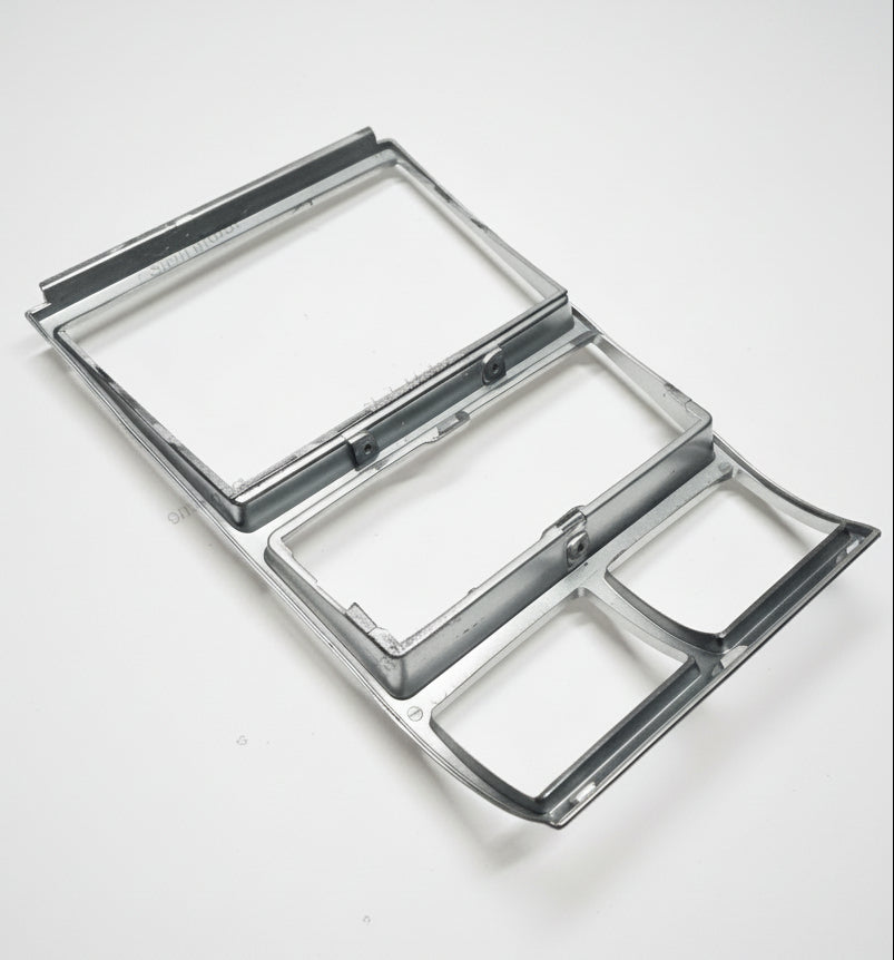 Metallic rectangular object with reflective surface on a white background
