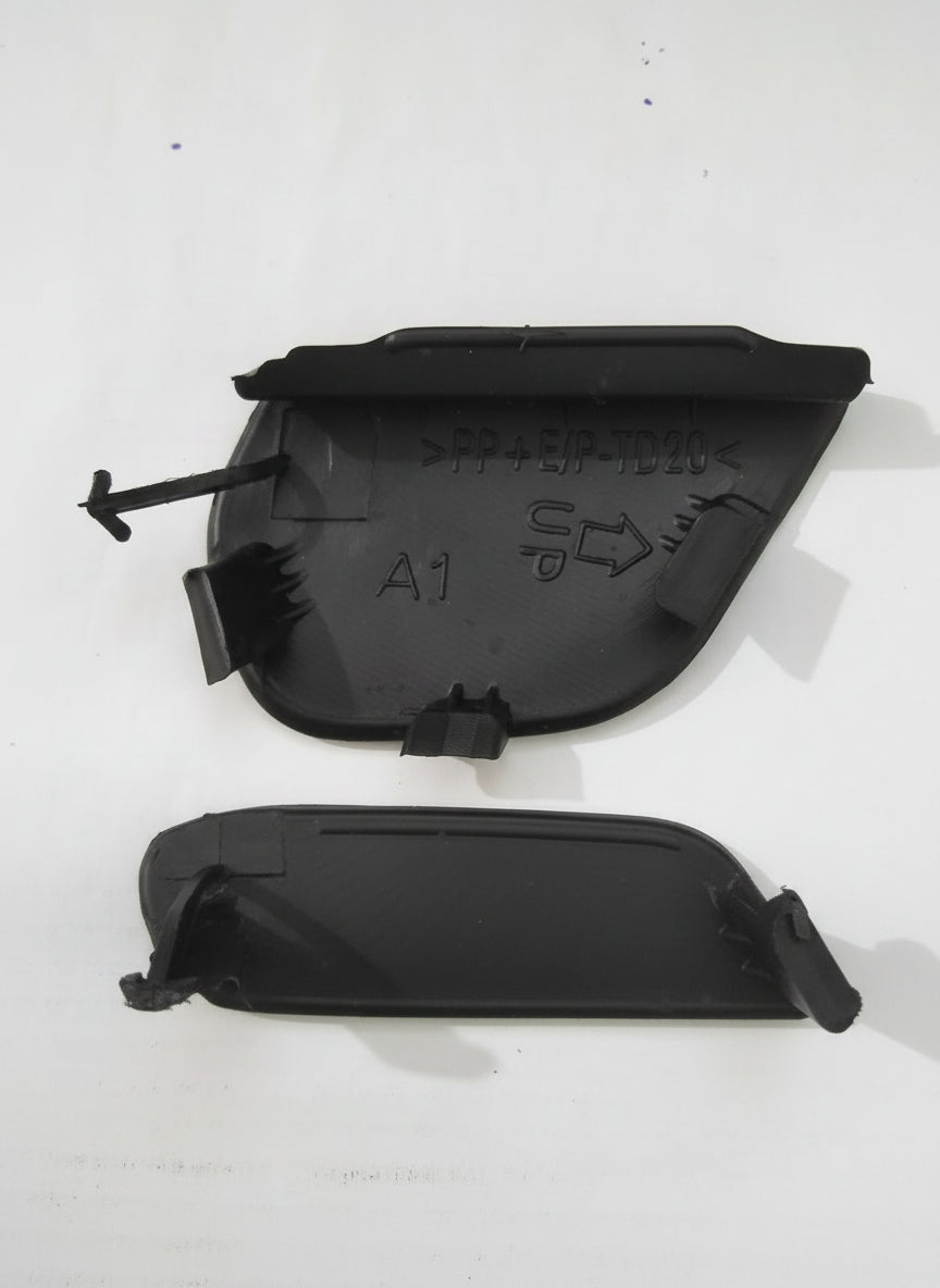 Two black plastic components on a white background