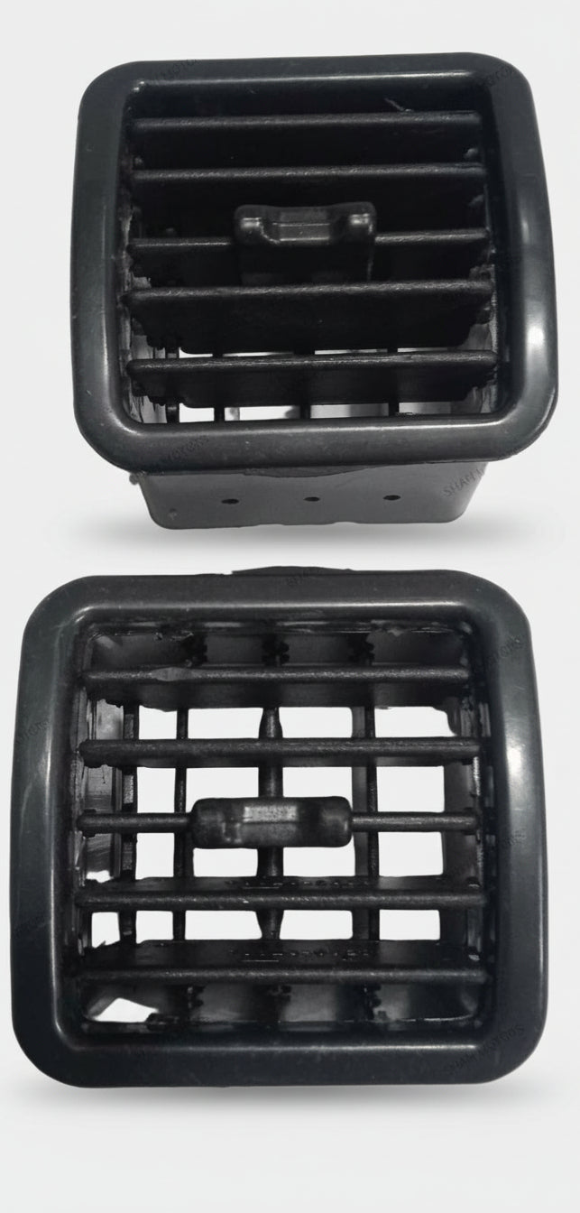 Two black plastic grates on a white tiled floor