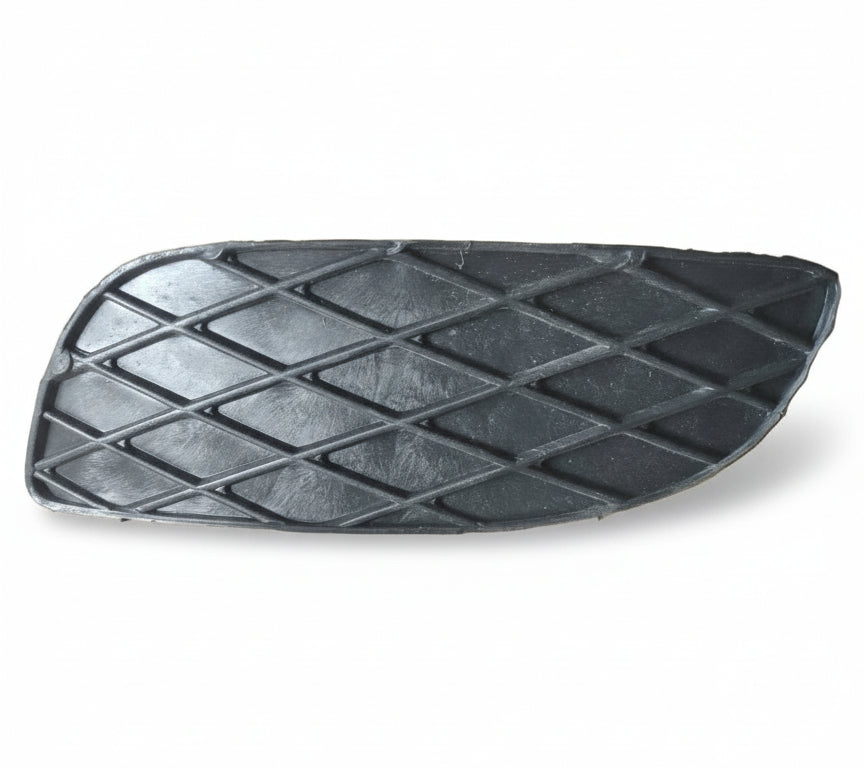 Black textured car pedal on a cardboard surface with a ruler for scale.