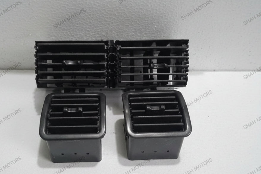 Set of black plastic components on a white surface with a gray background