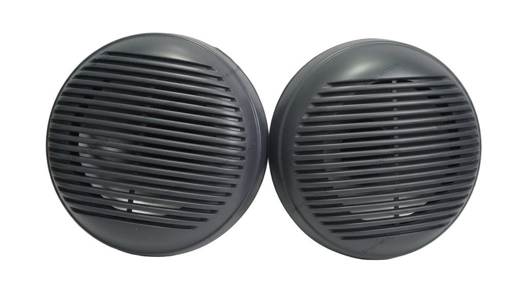 Two black circular objects with grid patterns on a white surface.