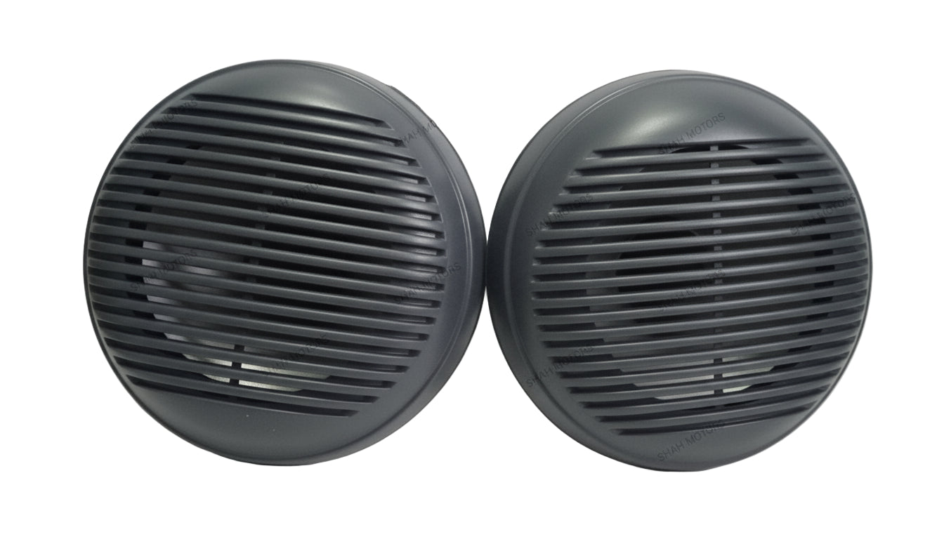 Two black circular objects with grid patterns on a white surface.