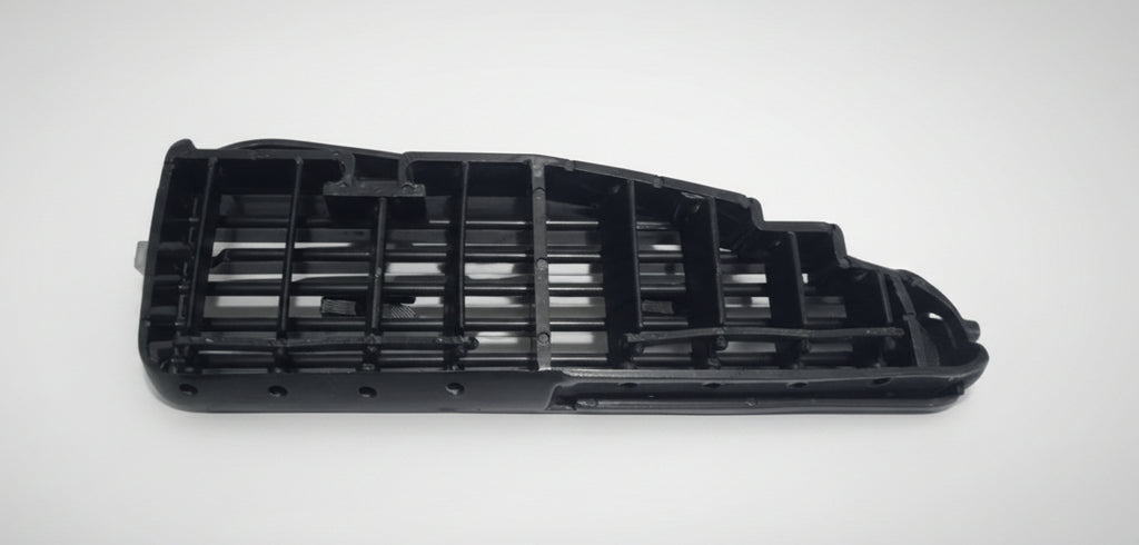 Black plastic component on a white background