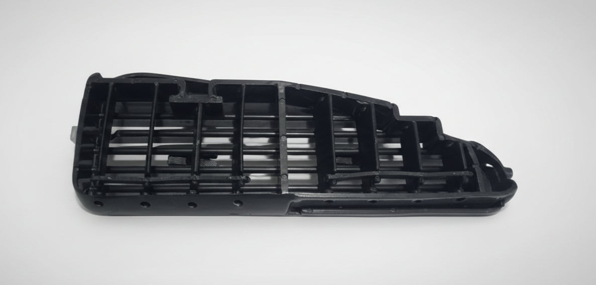 Black plastic component on a white background