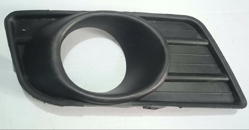 Black plastic component on a white tiled floor