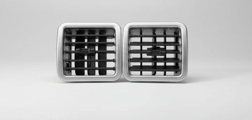 Two metallic air vent grilles on a white background