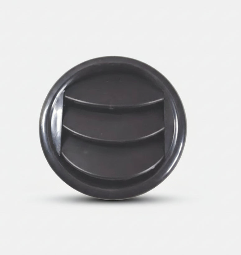 Black plastic component on a white background