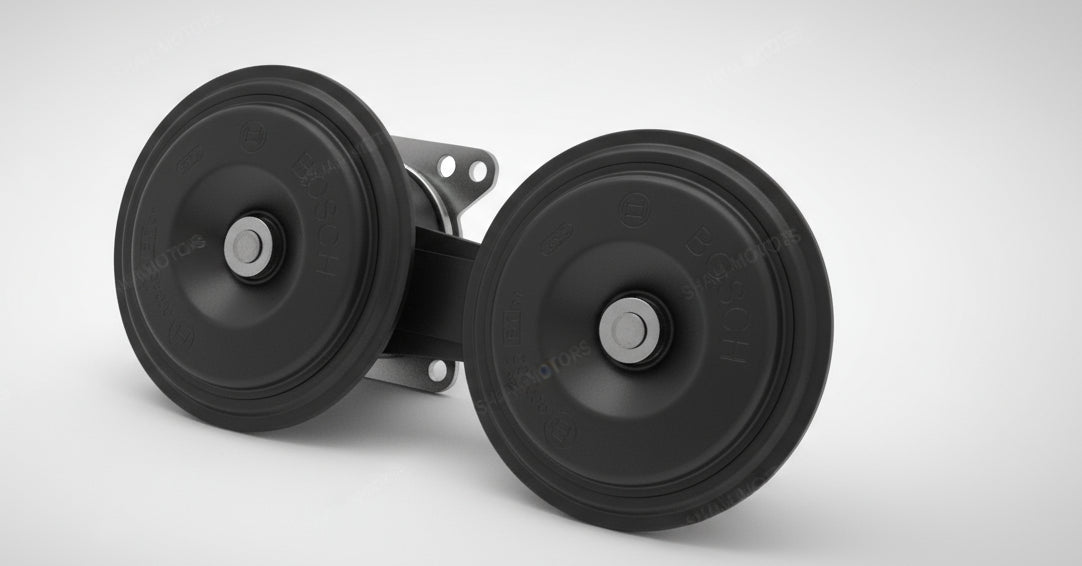 Two black rubber wheels with metal axles on a light gray tiled floor.