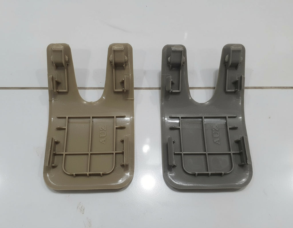 Two plastic components on a white tiled floor