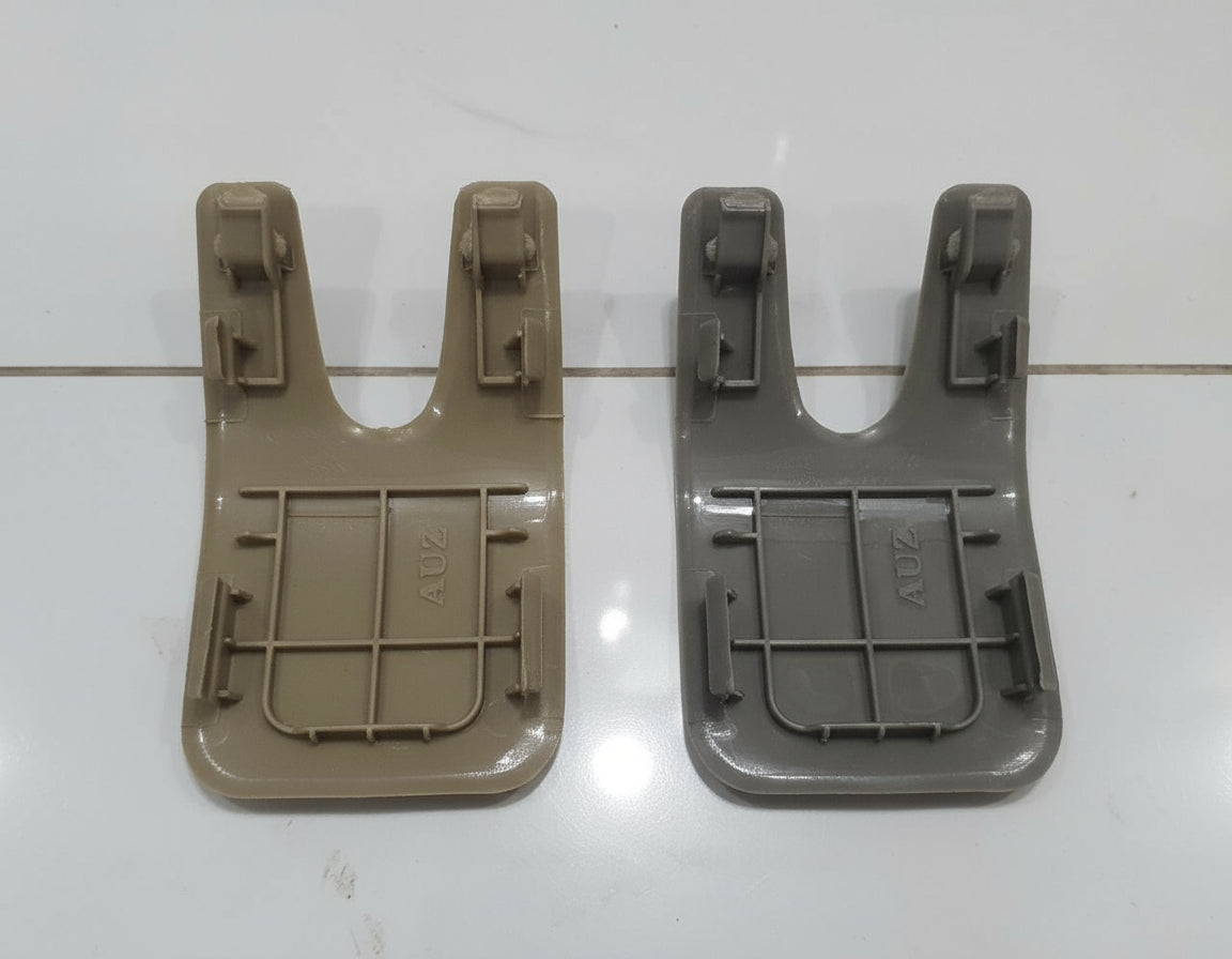 Two plastic components on a white tiled floor