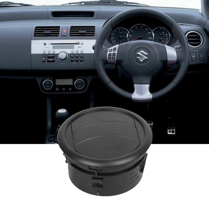 Car interior with steering wheel and dashboard, featuring a black car speaker below.