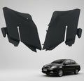 Black car side skirts on a white background with a car model for scale.