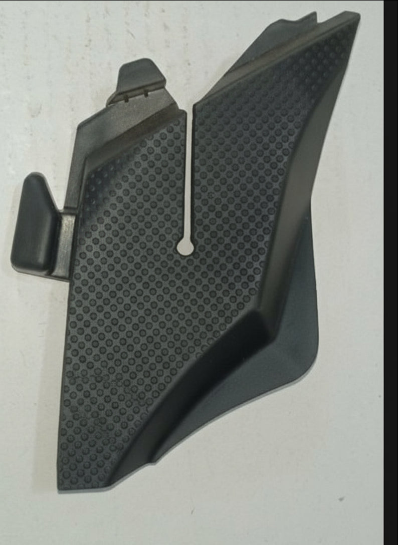 Black plastic car component on a light gray background