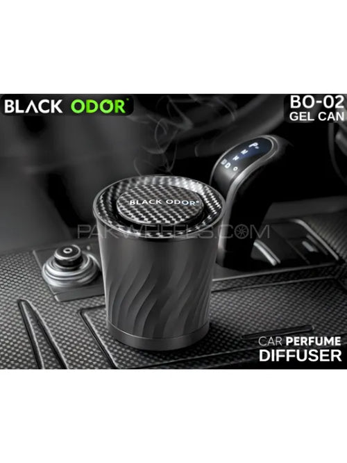 Car perfume diffuser with 'Black Odor' branding on a car dashboard.