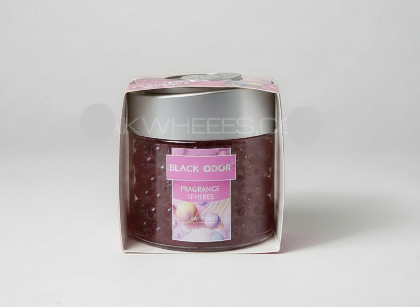 Jar of 'Black Odor' fragrance spheres in packaging on a textured surface.