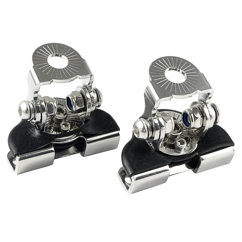 Pair of metal ski bindings on a white background