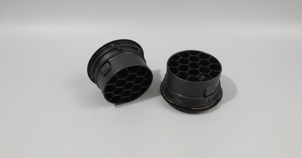 Two black rubber gaskets on a gray background