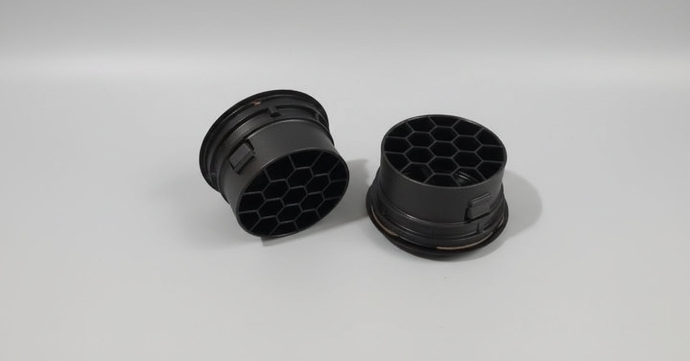 Two black rubber gaskets on a gray background